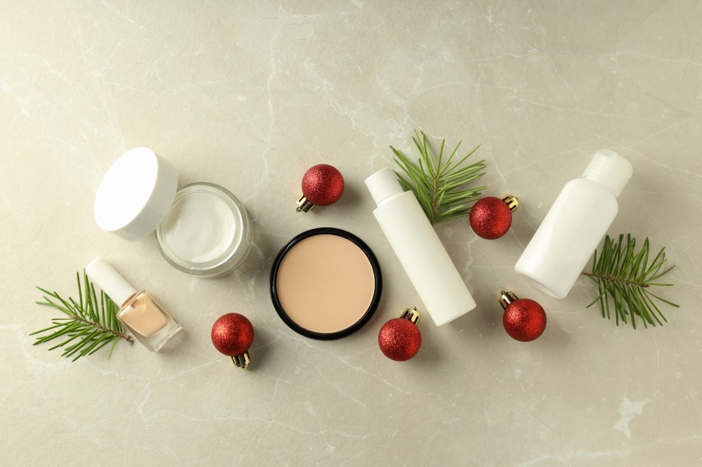Composition with winter cosmetic products on light textured background