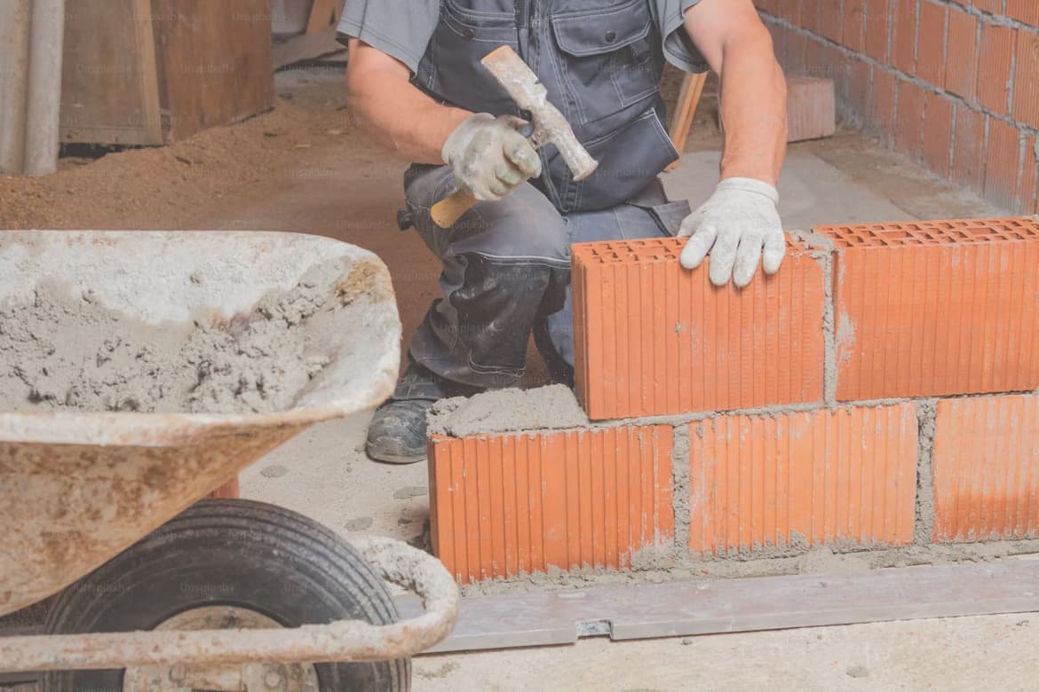construction-worker-bricklaying-the-wall-with-mortar