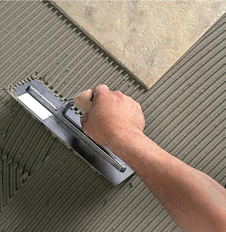 a-person-applying-tile-adhesive
